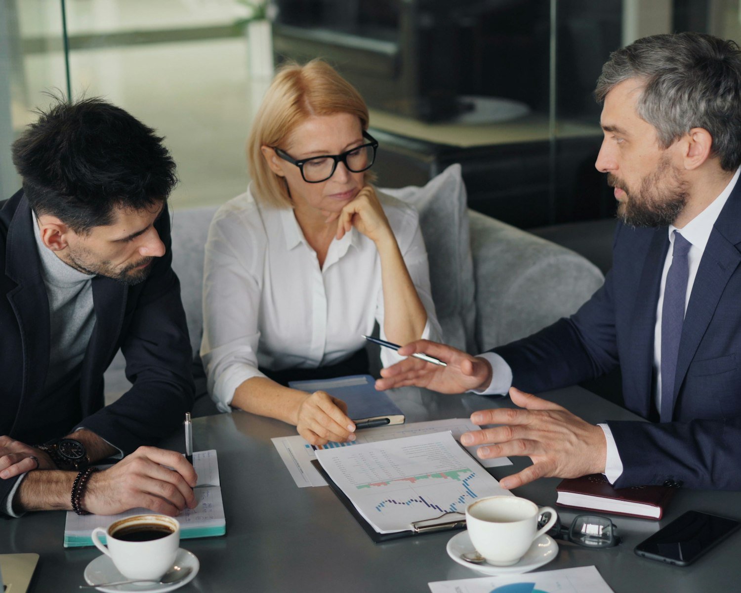 Specialists reviewing a report in a meeting